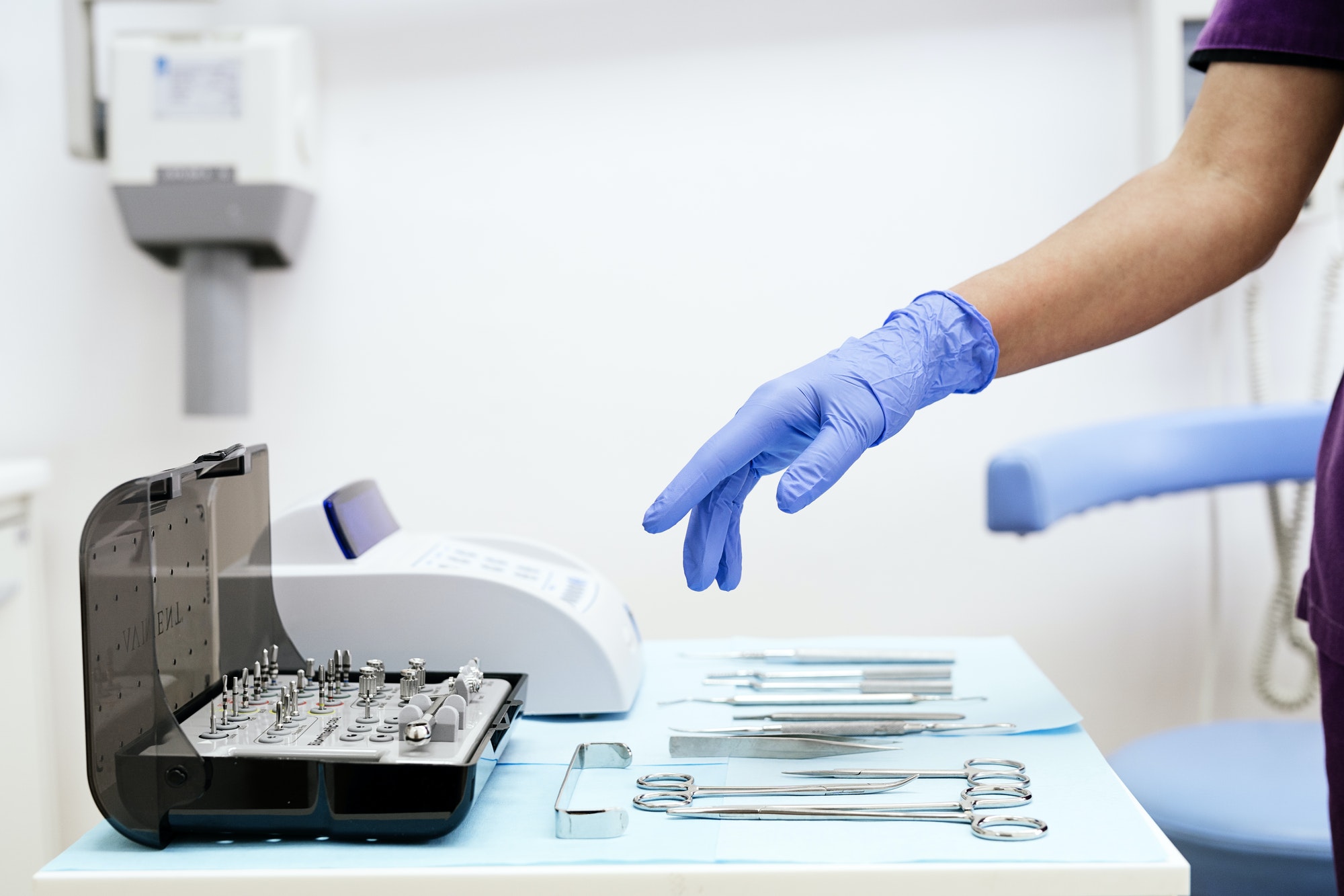 detail of hand holding dental tools in dental clinic